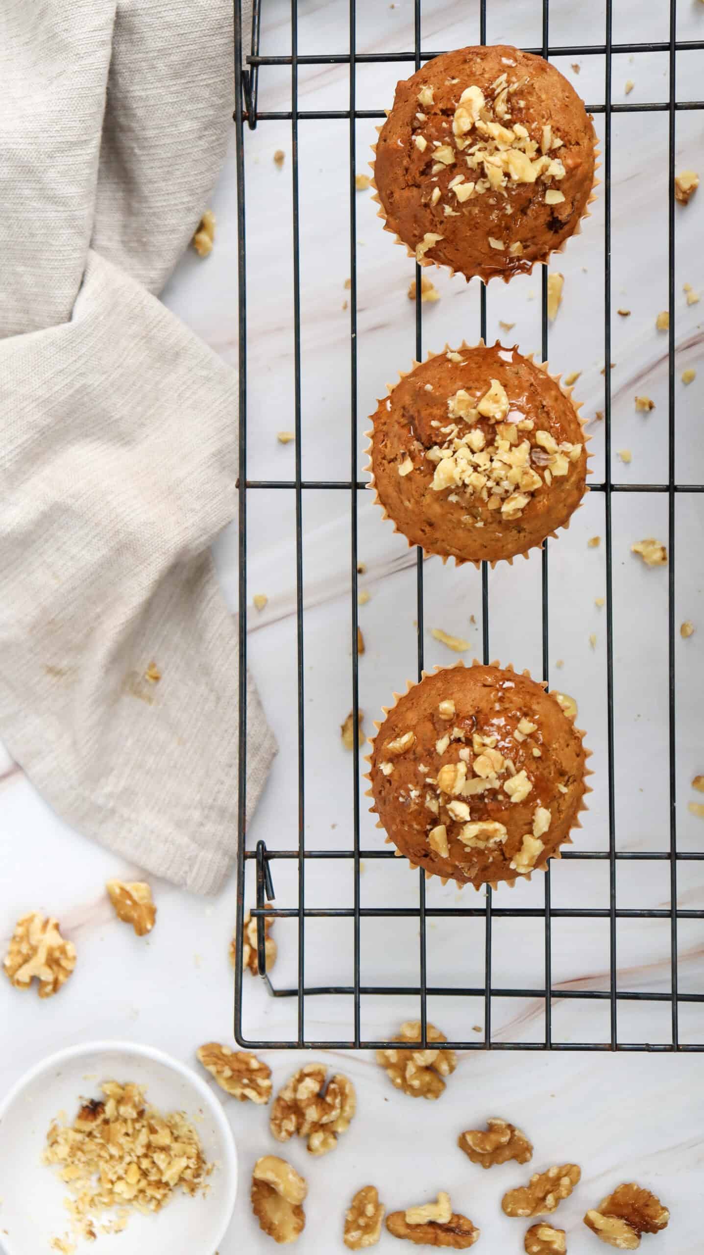 Top view of three pieces carrot cake muffins on a cooling rack.