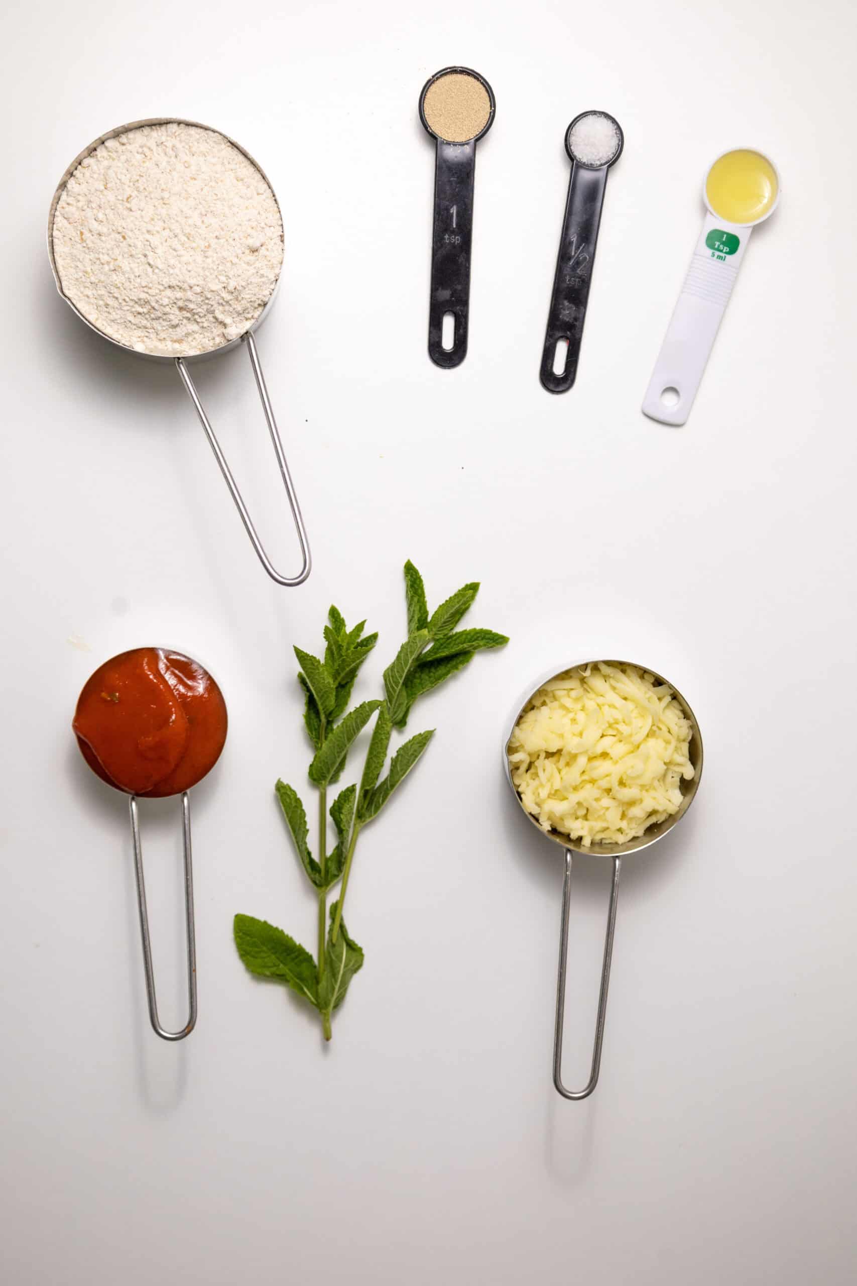 Overhead image of the ingredients for homemade Margherita pizza.