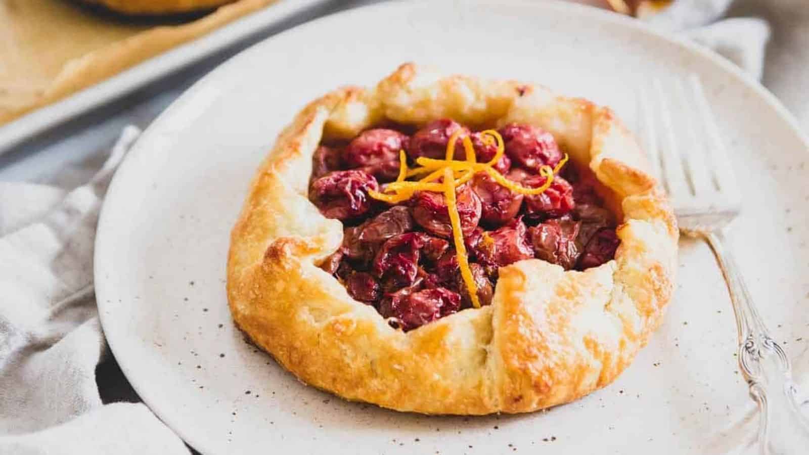 Close-up image of mini tart galette with a fork on a plate.