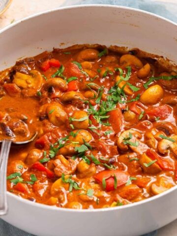 An image of cooked mushroom masala in a skillet.