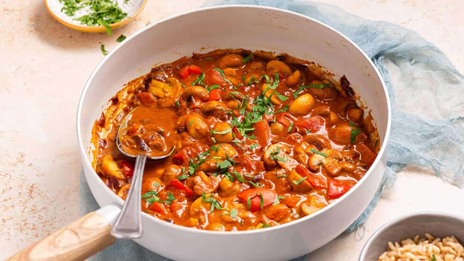 An image of cooked mushroom masala in a skillet.