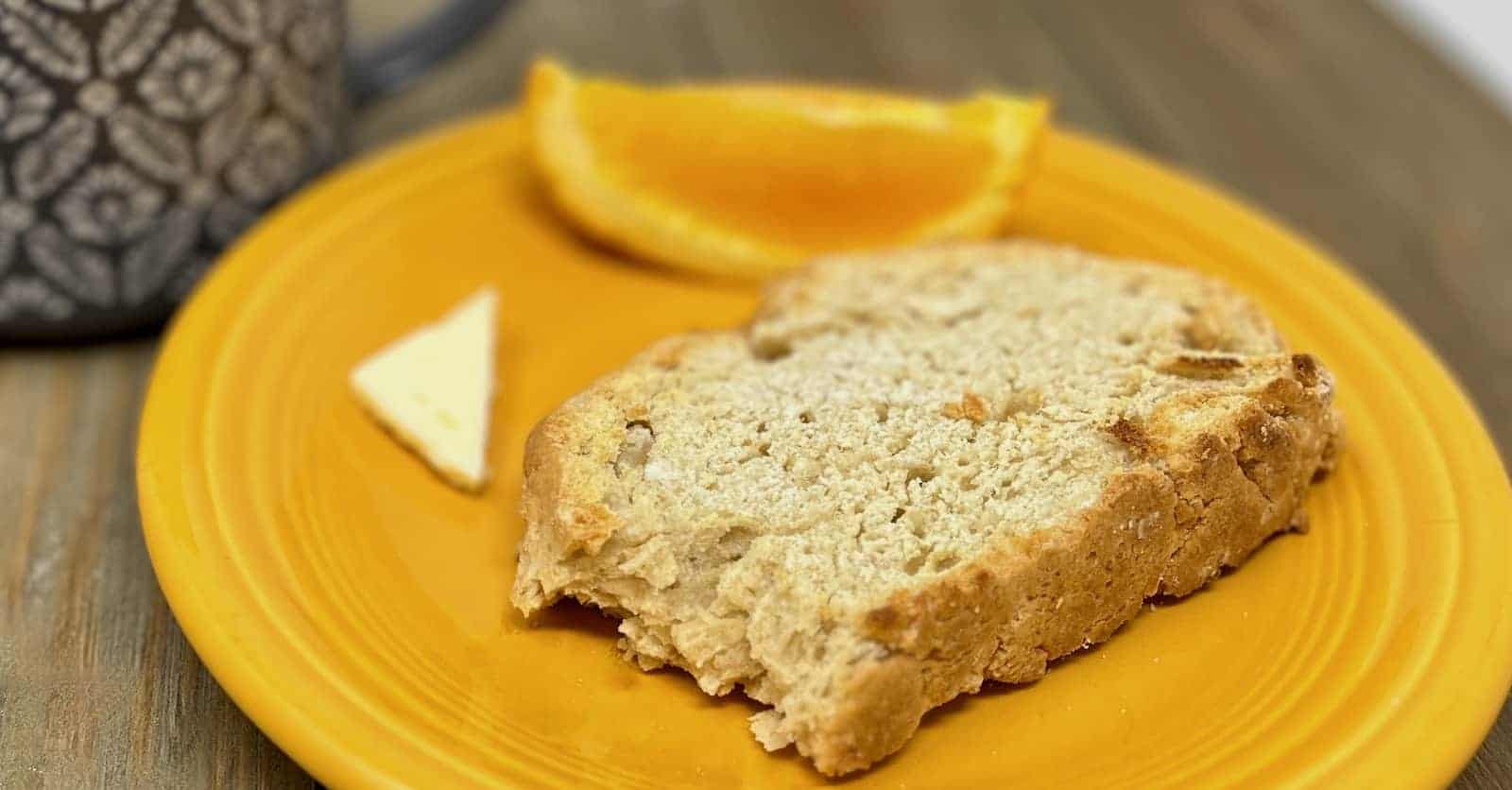 A slice of no yeast quick bread on a yellow plate.