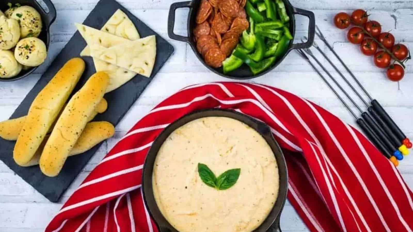 Overhead image of pizza fondue in a pan with various pizza ingredients.