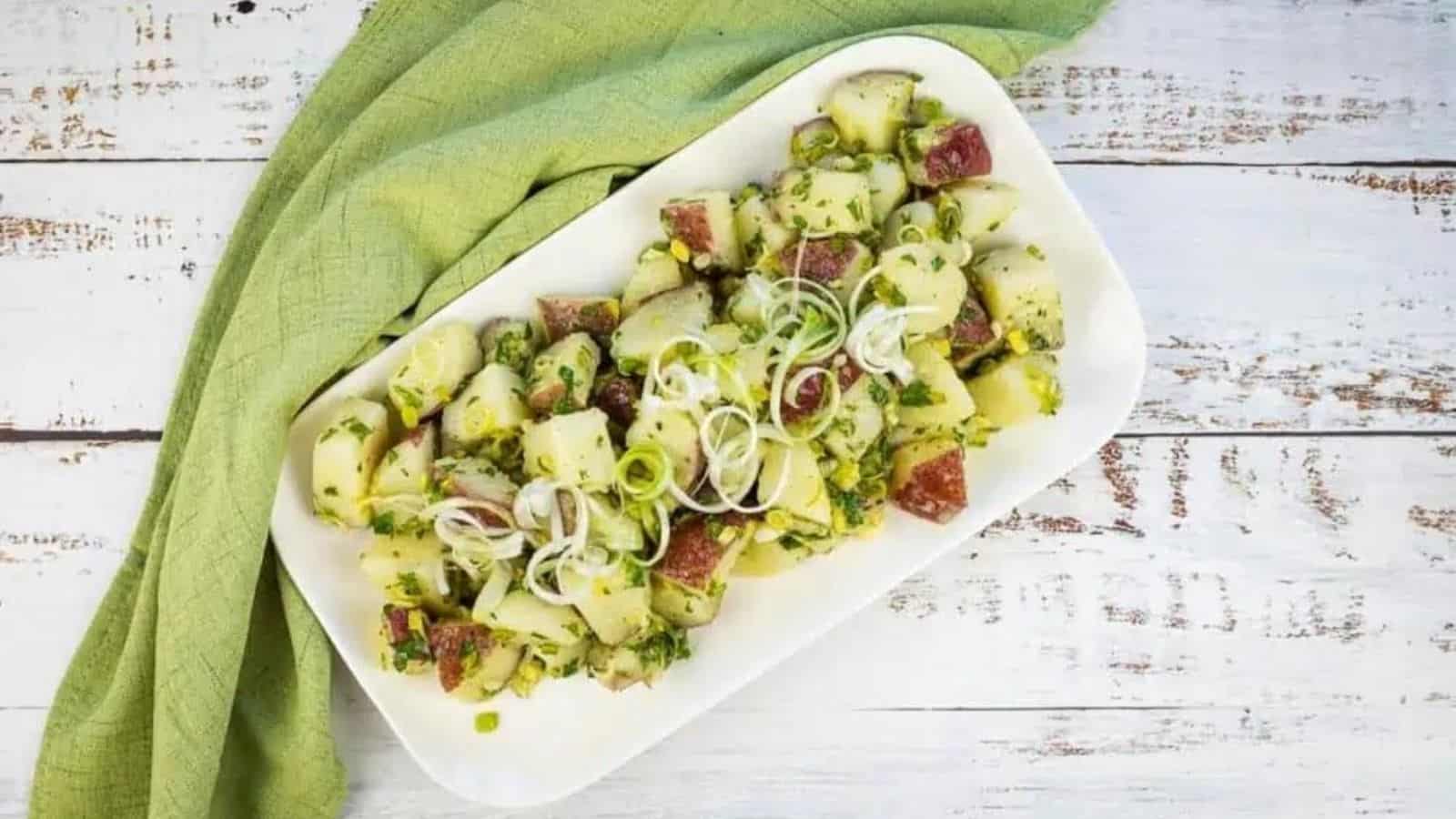 Ovrhead image of potato salad with fresh herbs on a plate.