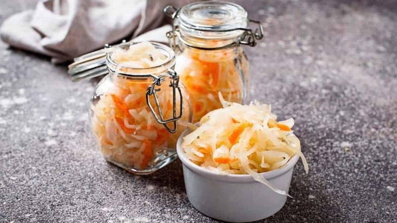 Homemade sauerkraut in jars and mini bowl.