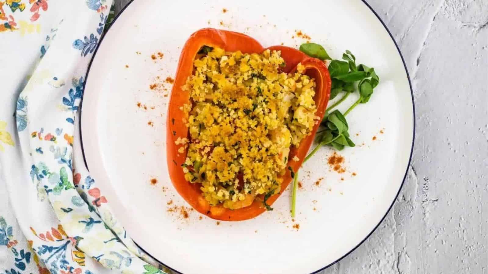 Overhead image of seafood stuffed bell pepper on a plate.