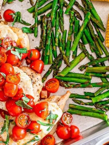 Overhead image of sheet pan chicken caprese and vegetables.