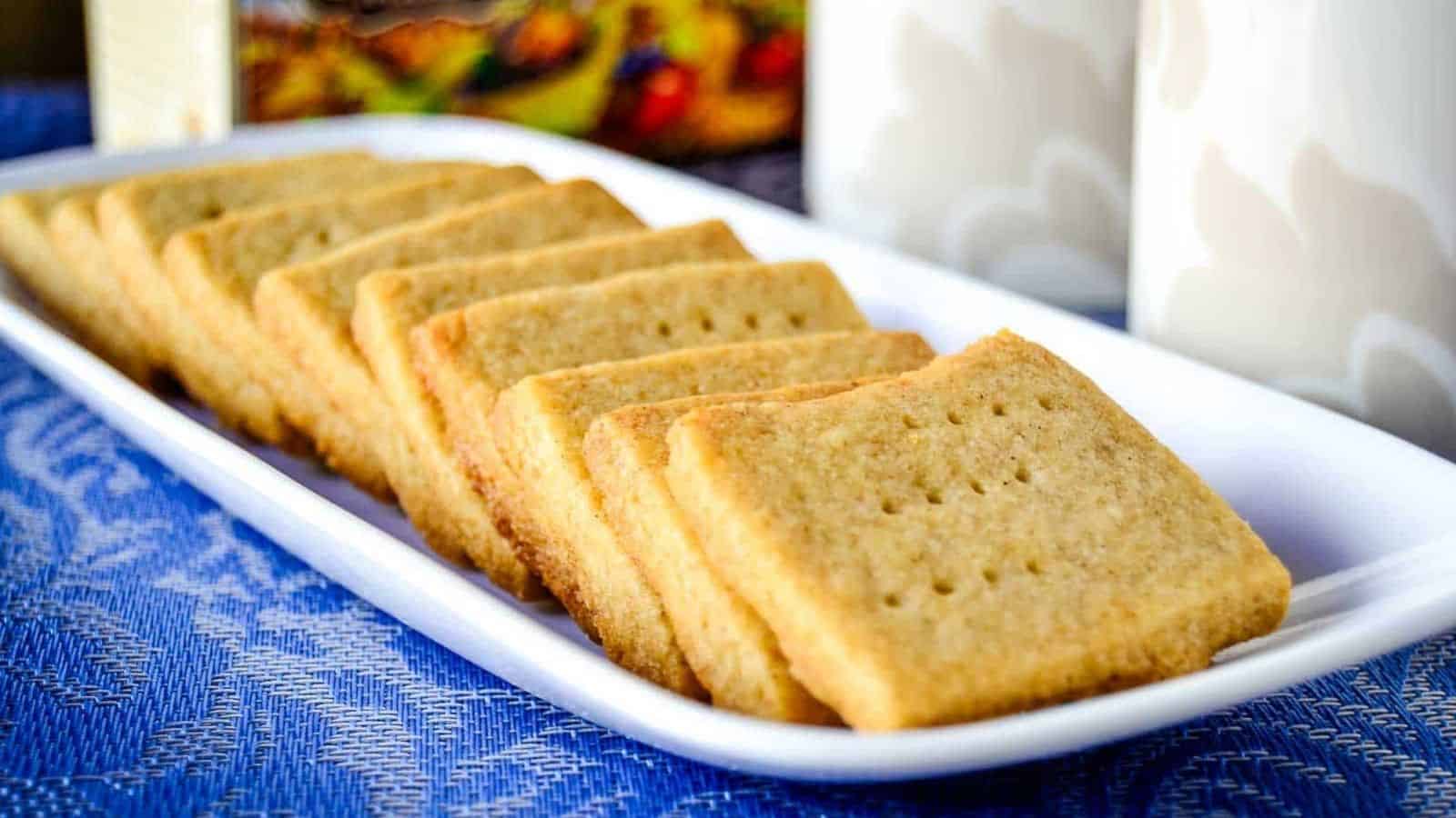 A white plate of a line of Spiced Shortbread Cookies lined up.