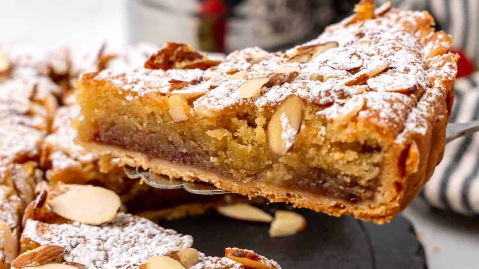 A slice of a strawberry jam Bakewell tart.