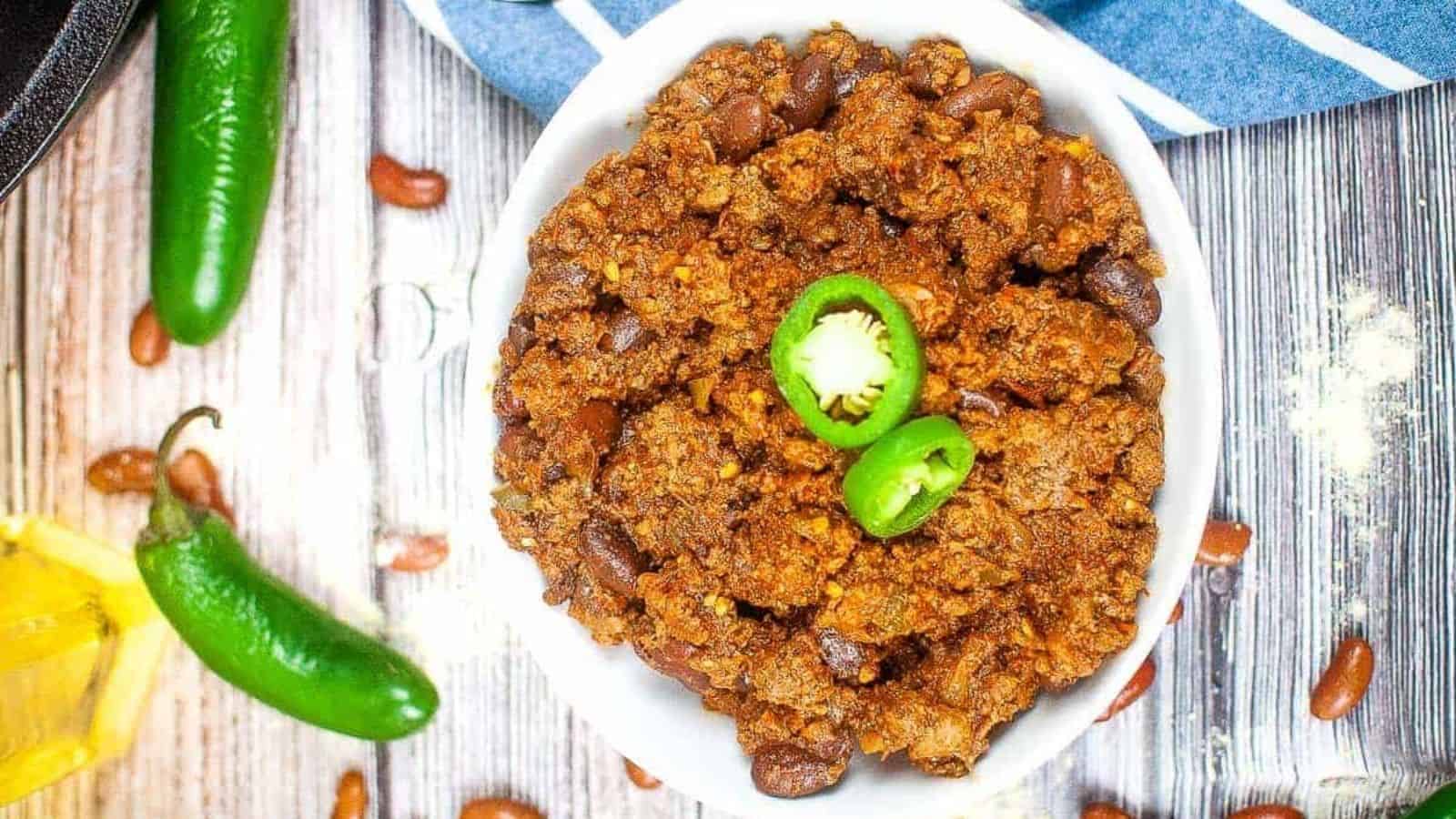 A bowl of Texas roadhouse chili with jalapenos and beans.