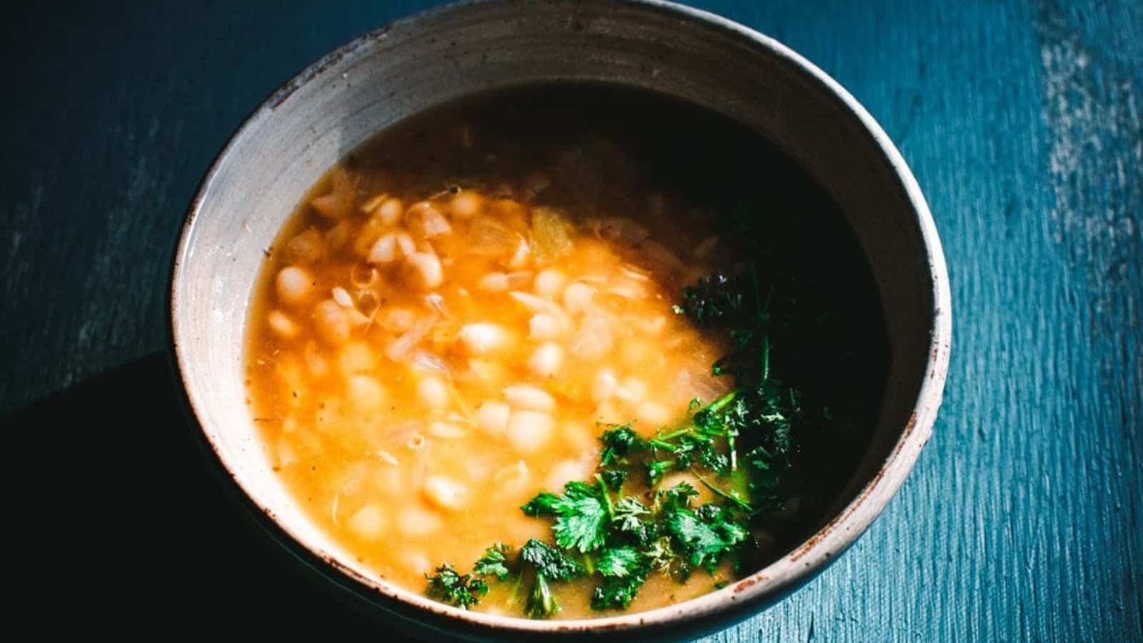 Close-up image of vegan spiced white bean soup in a bowl.