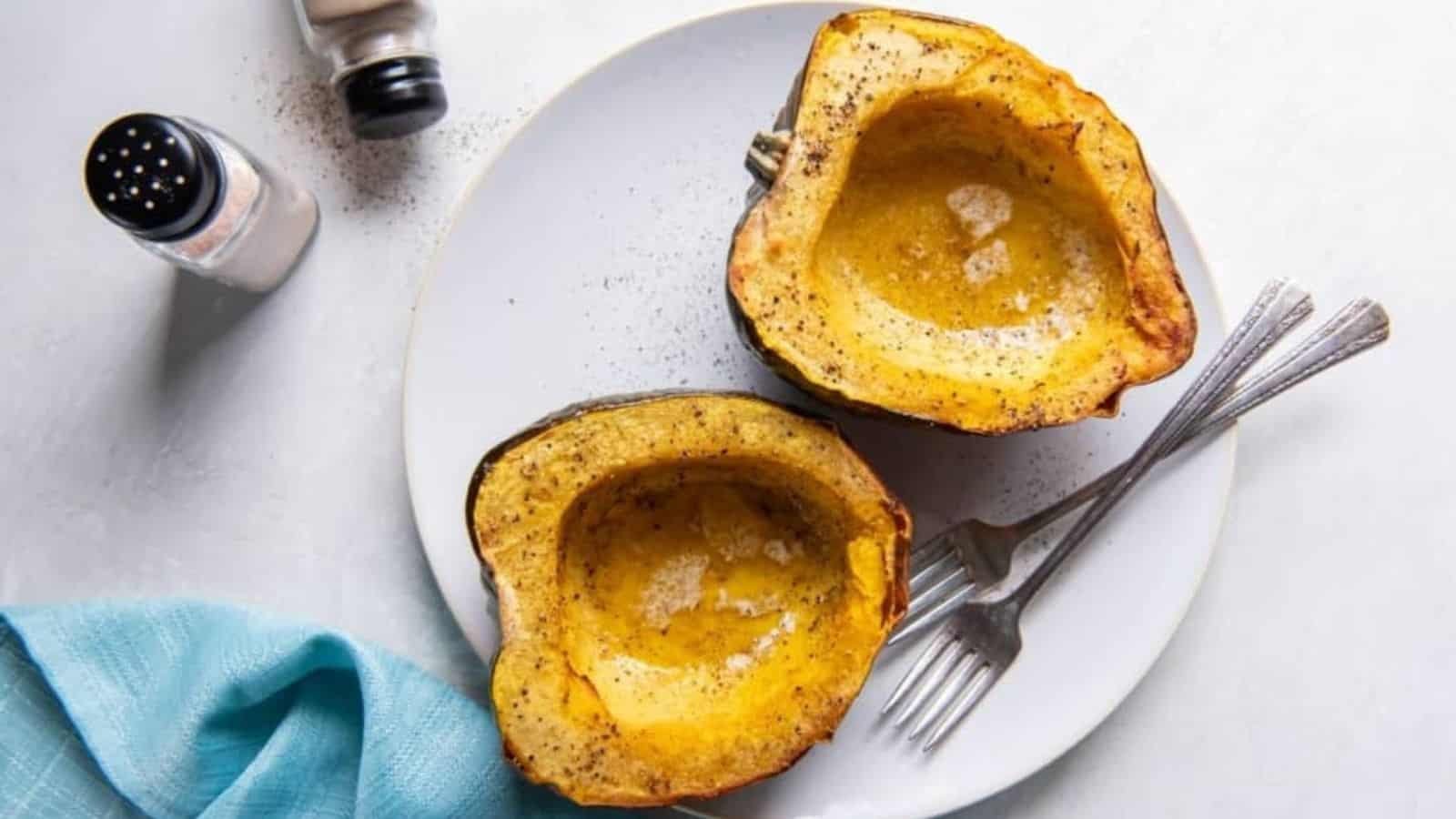 Overhead image of air fryer acorn squas with forks on a plate.