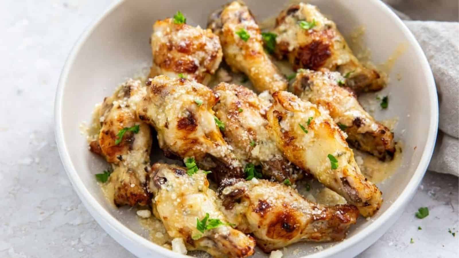 Air Fryer Garlic Parmesan Wings in a white bowl with parsley.