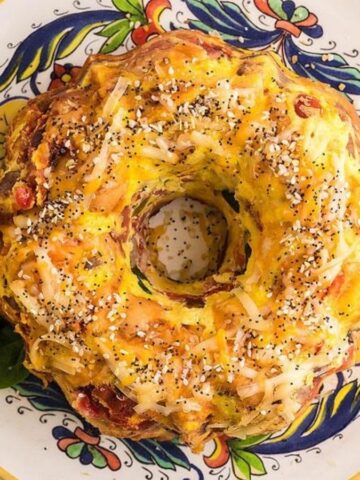 Overhead image of air fryer loaded bagel breakfast casserole on a plate.