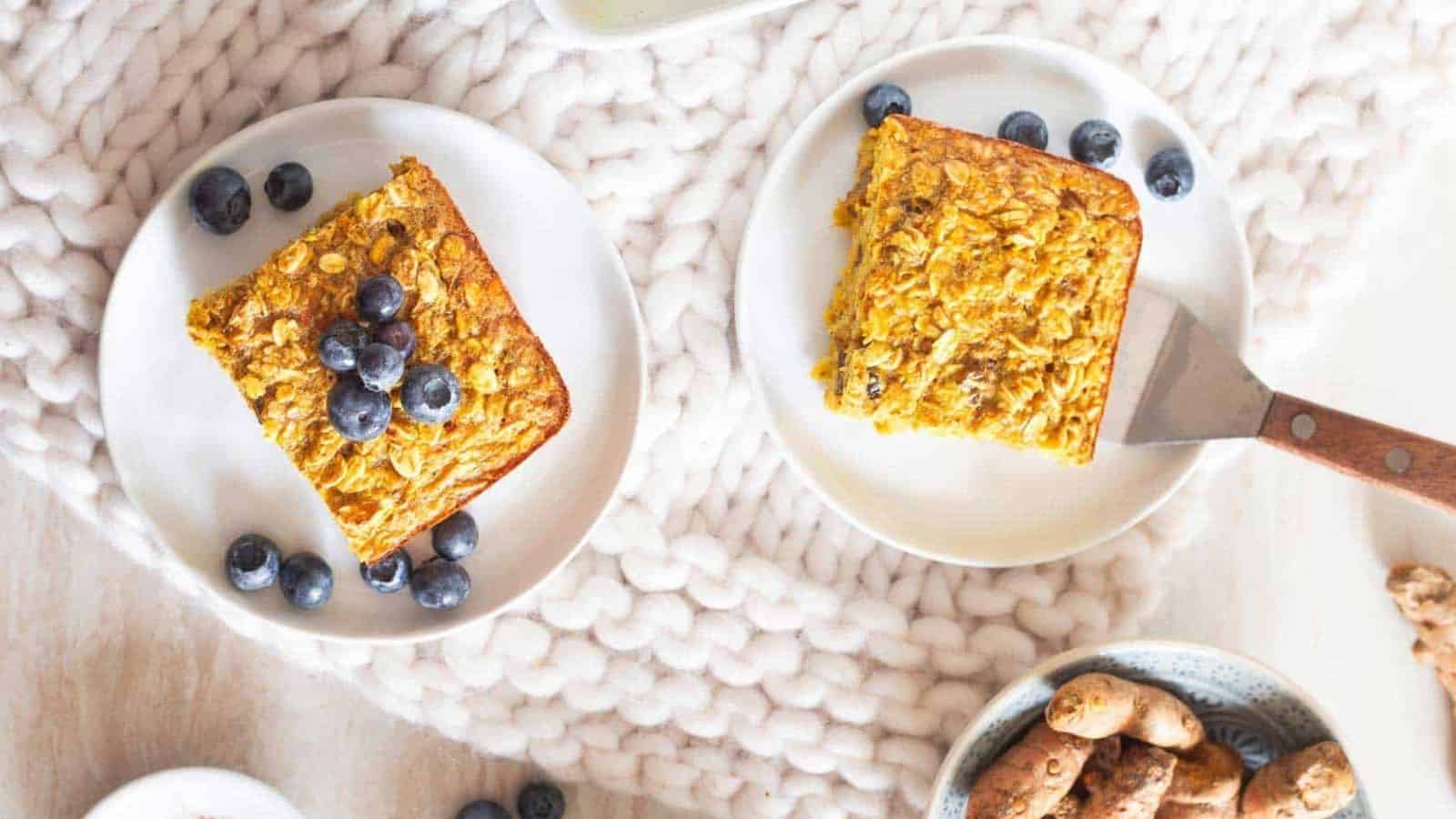 Overhead image of two plates of baked turmeric oatmeal.