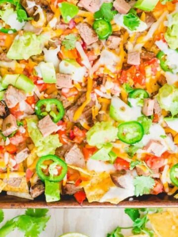Overhead image of carne asada nachos in a tray.