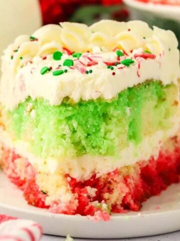 A slice of Christmas Poke Cake on a plate.