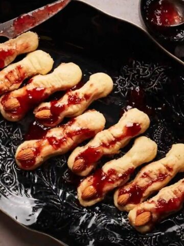 A plate of Creepy Halloween Witch Finger Cookies.