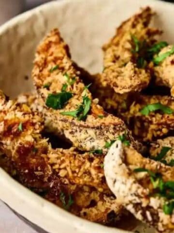 Close-up image of crispy air fryer portobello muushroom fries with dip.