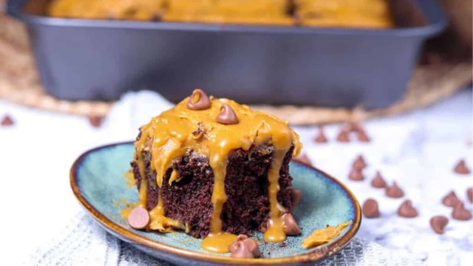 Close-up image of a slice of decadent chocolate salted caramel cake on a plate.