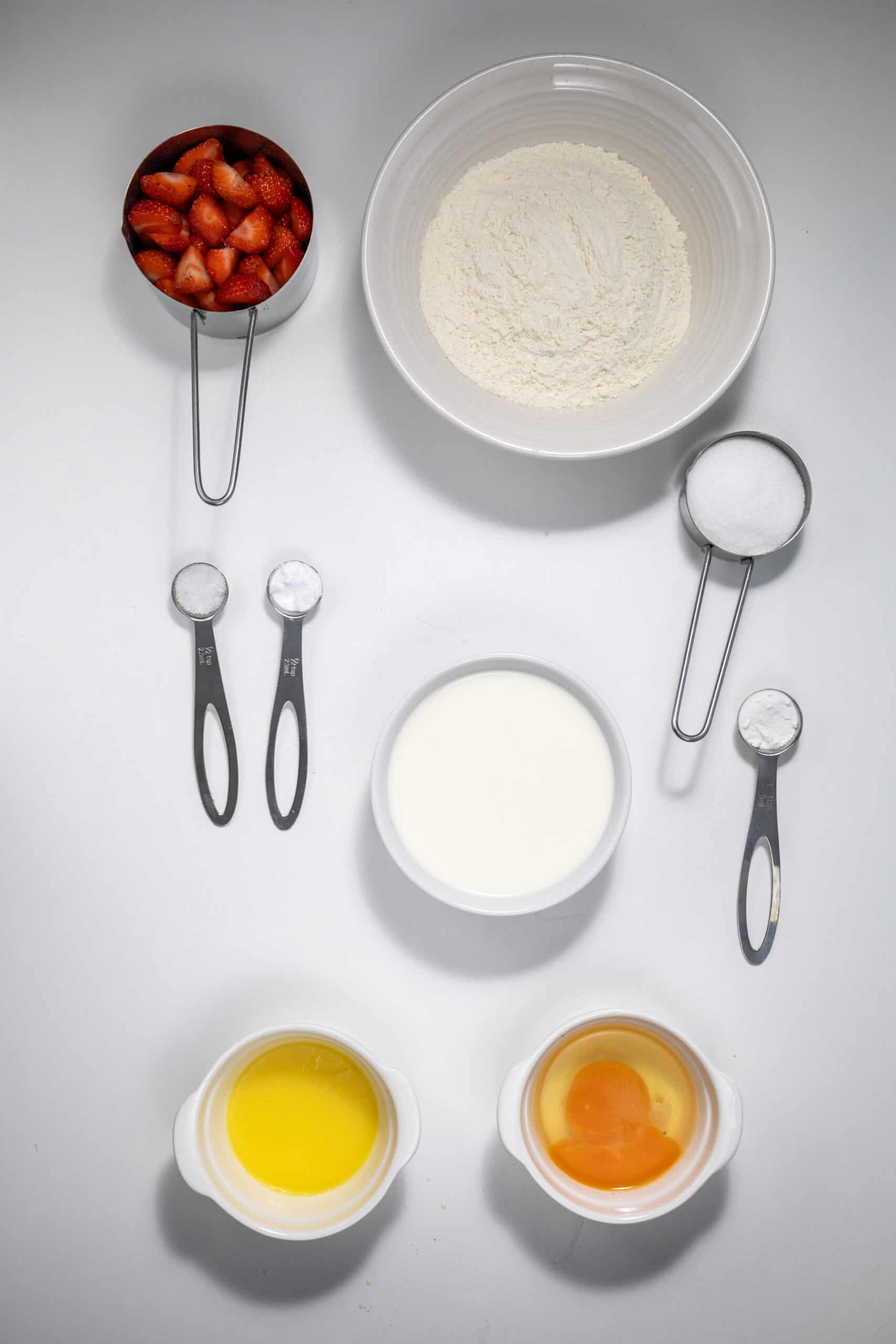 "Overhead image of the ingredients for Strawberry Delight Pancakes.