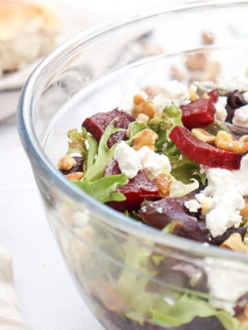 Close-up image of Grilled Beetroot and Goat Cheese Salad in a glass bowl.