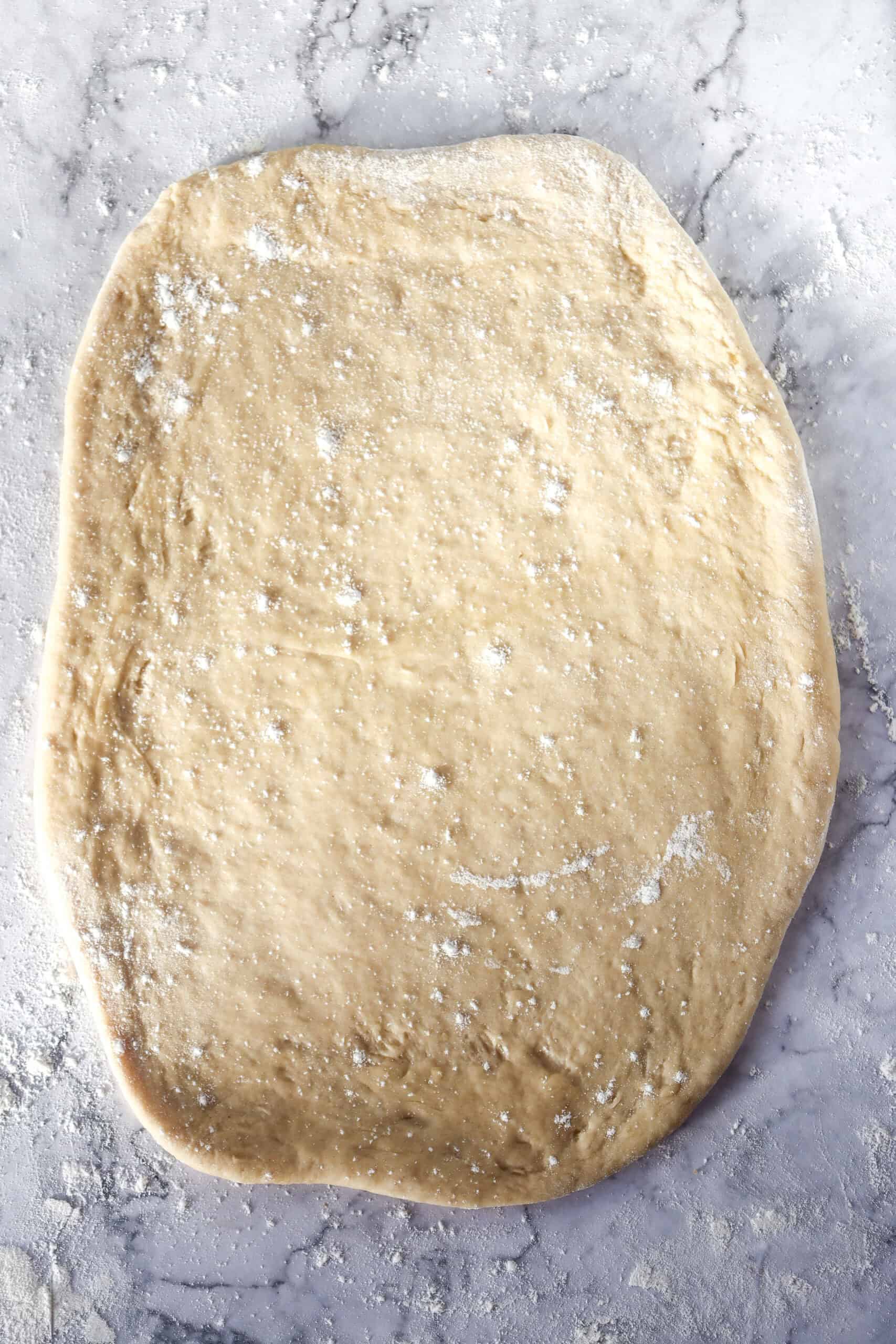 Dough rolled flat into a thin rectangle, ready for the filling to be added.