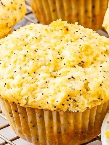 Close-up image of lemon poppy seed muffins on cooling rack.