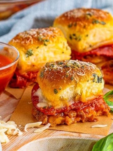 Pizza Sliders on a wooden board.