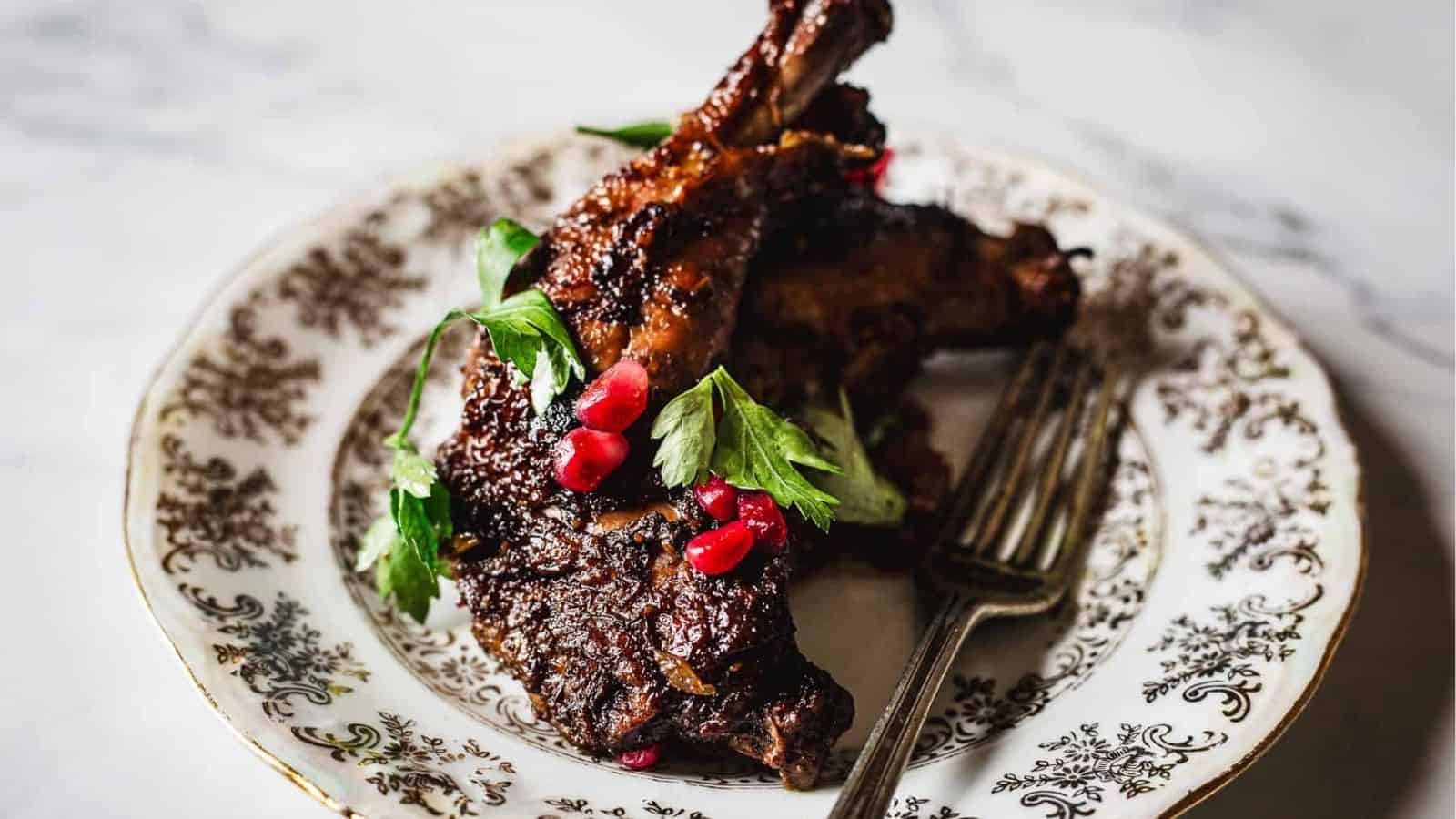 Pomegranate chicken with walnuts on a plate.