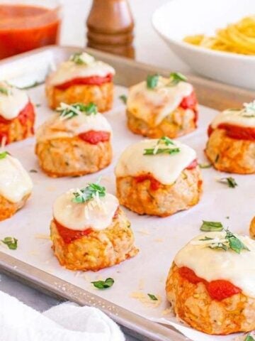 Close-up image of sheet pan chicken parmesan meatballs.