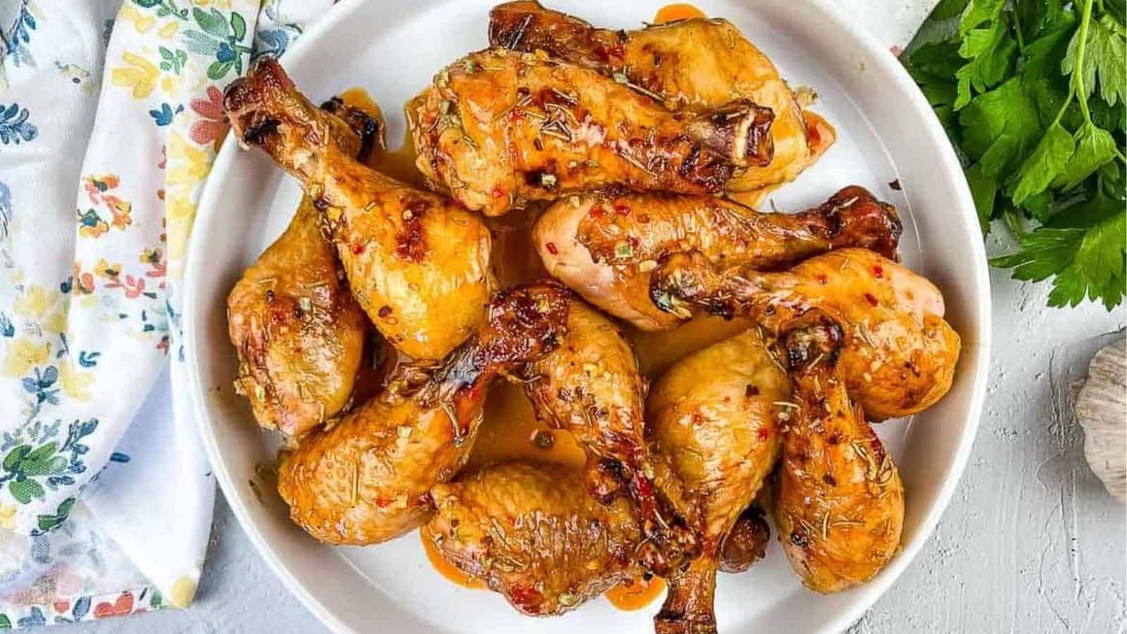 Smoked Chicken Legs with Red Pepper Glaze on a round platter.