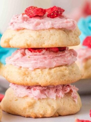 Three stacks of Sour Cream Cookies with more on the background.