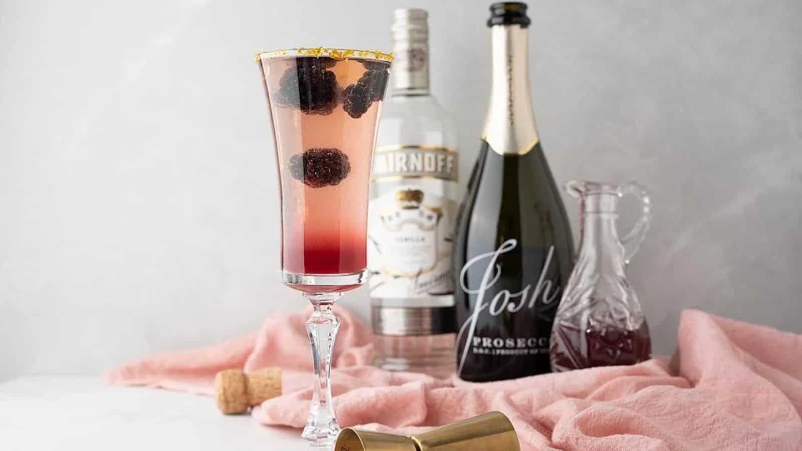 A glass of Sparkling Meyer Lemon Blackberry Jam Prosecco Cocktail.