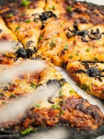 Slices of Spider Halloween Pizza with Black Charcoal Crust.