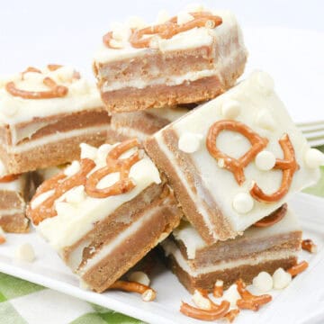 Close-up image of a batch of cooked White Chocolate Pretzel Pumpkin Blondies arranged on a tray.