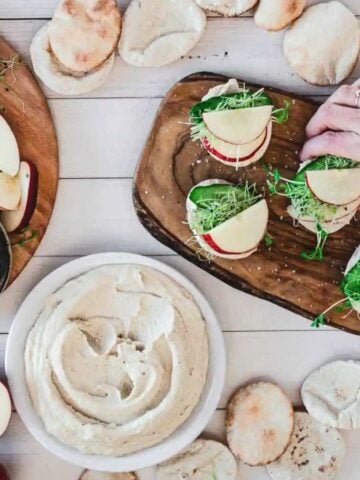 Someone holding an Apple and Hummus Pita Bread.