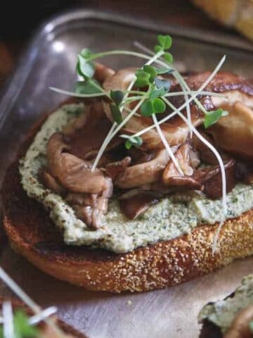 A close-up view of Balsamic Pickled Shiitake Crostini on a tray.