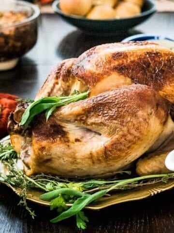A buttermilk brined roasted surrounded by festive holiday side dishes.