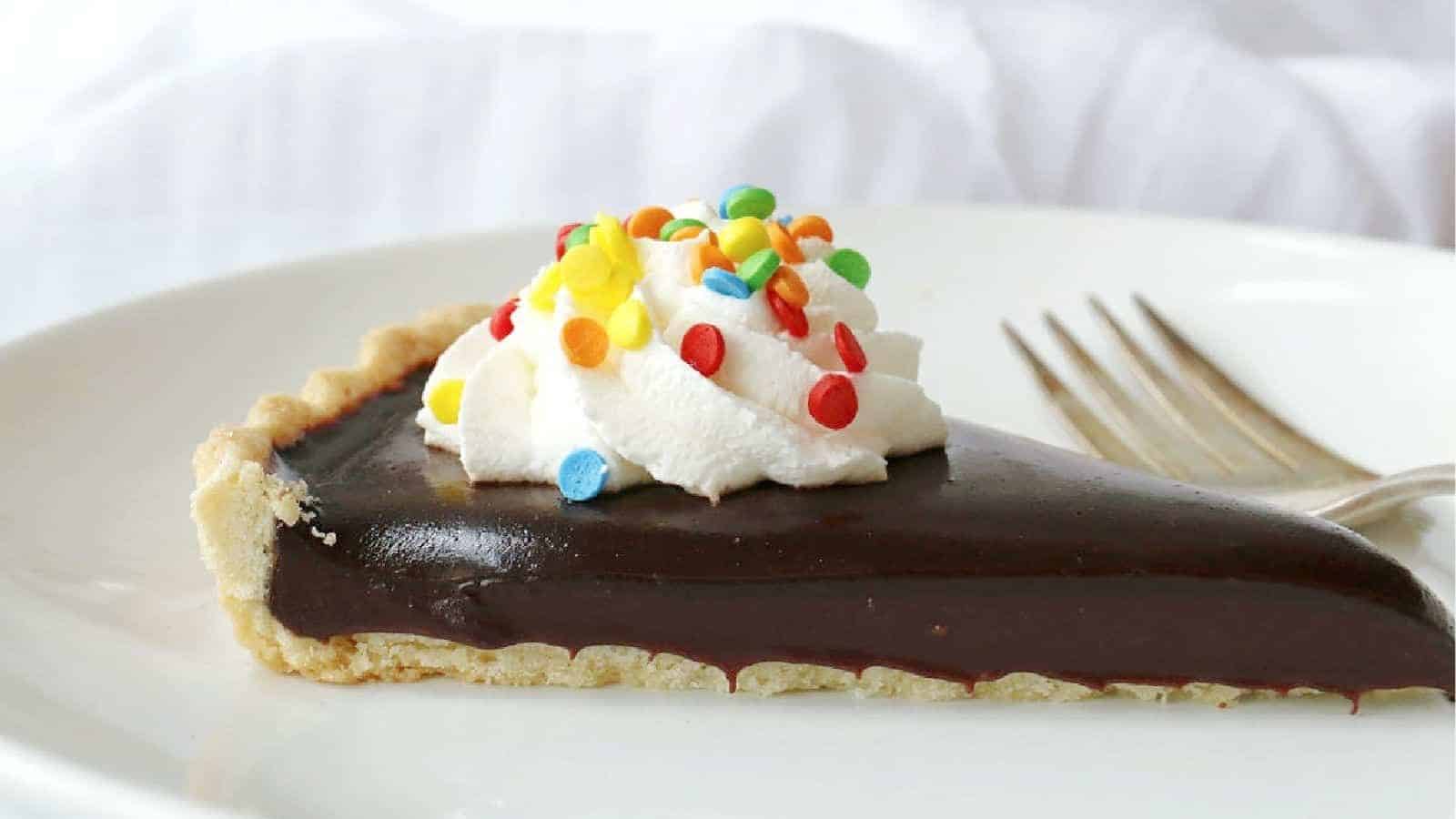 A slice of a chocolate ganache tart.