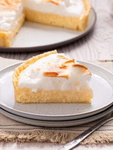 An image of a slice of coconut cream pie on a plate.