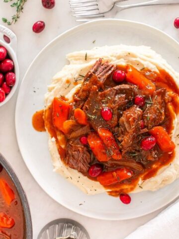 Top view of Cranberry Balsamic Roast Beef on top of mashed potatoes.