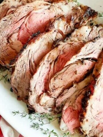 Overhead image of garlic herb prime rib roast on a serving dish.