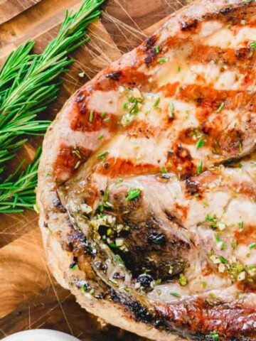 Top view of a Grilled Ham Steak on a wooden board.