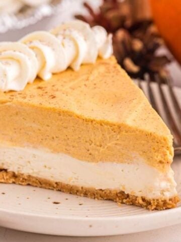 A slice of No Bake Pumpkin Pie Cheesecake on a plate with a fork.