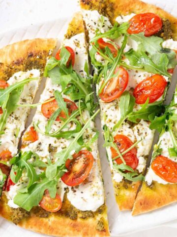 Slices of pesto flatbread on a plate.