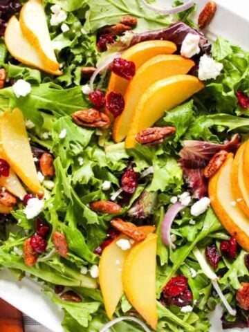 An overhead image of roasted pear salad on a serving plate.