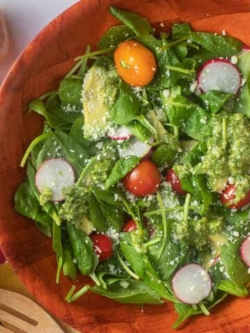 A bowl of spinach avocado salad.