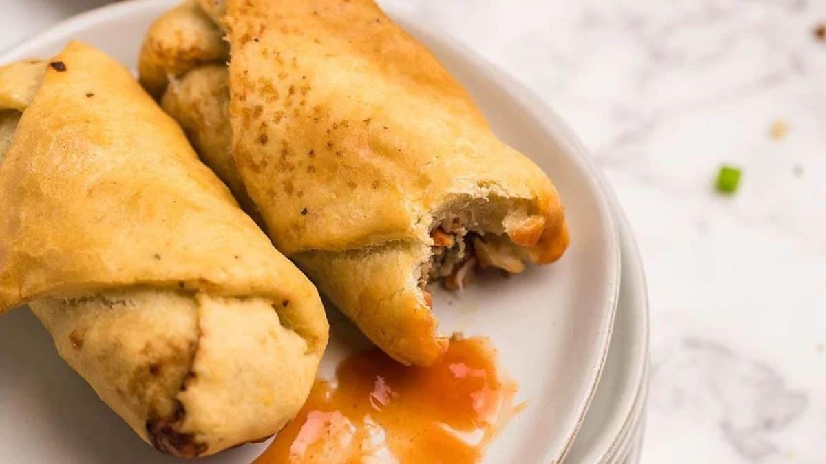 Two Air Fryer Egg Roll Wrappers on a stack of plates.