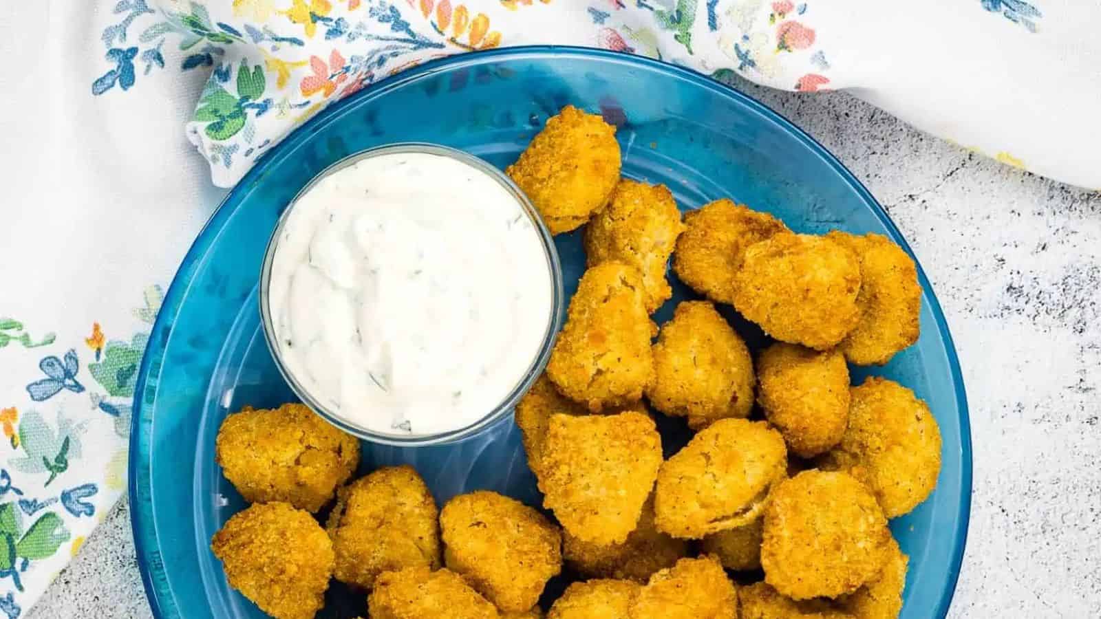 Top view of a plate of Air Fryer Popcorn Chicken with a dip.